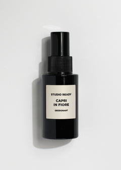 Black spray deodorant bottle with beige label reading Capri in Fiore Studio Ready