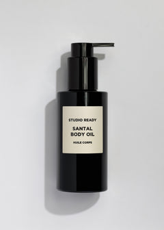 Studio Ready Santal Body Oil bottle with pump on a pale background.