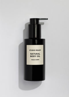 Black pump bottle of Studio Ready Natural Body Oil with beige label.